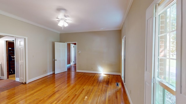 spare room featuring ceiling fan, hardwood / wood-style floors, and ornamental molding