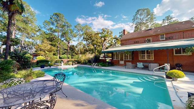 view of swimming pool with a patio