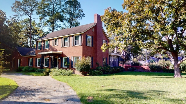 colonial-style house with a front lawn