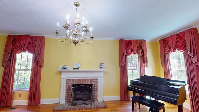 misc room with a fireplace, hardwood / wood-style floors, and crown molding