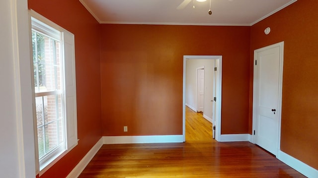 unfurnished room with crown molding and hardwood / wood-style flooring