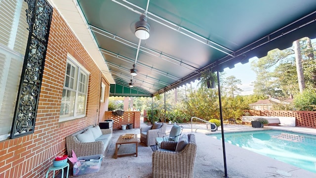 view of swimming pool featuring an outdoor living space, ceiling fan, and a patio area