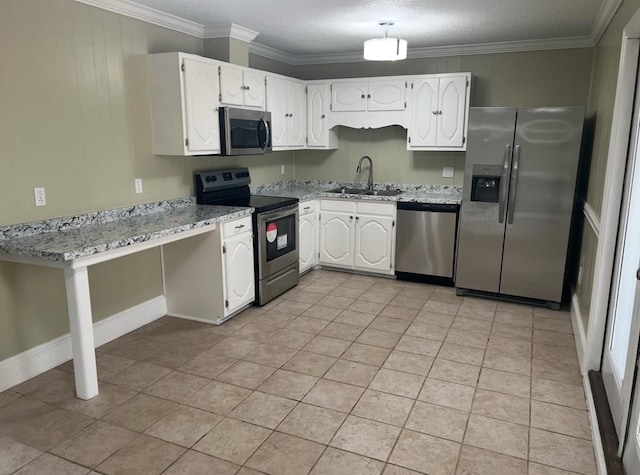 kitchen with appliances with stainless steel finishes, white cabinetry, a sink, and ornamental molding