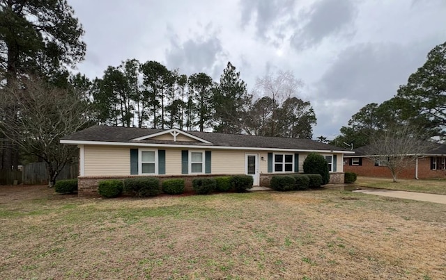 ranch-style house with brick siding and a front lawn