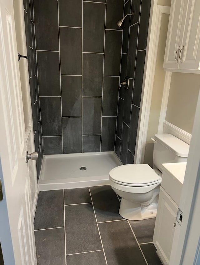 full bath featuring vanity, a shower stall, toilet, and tile patterned floors