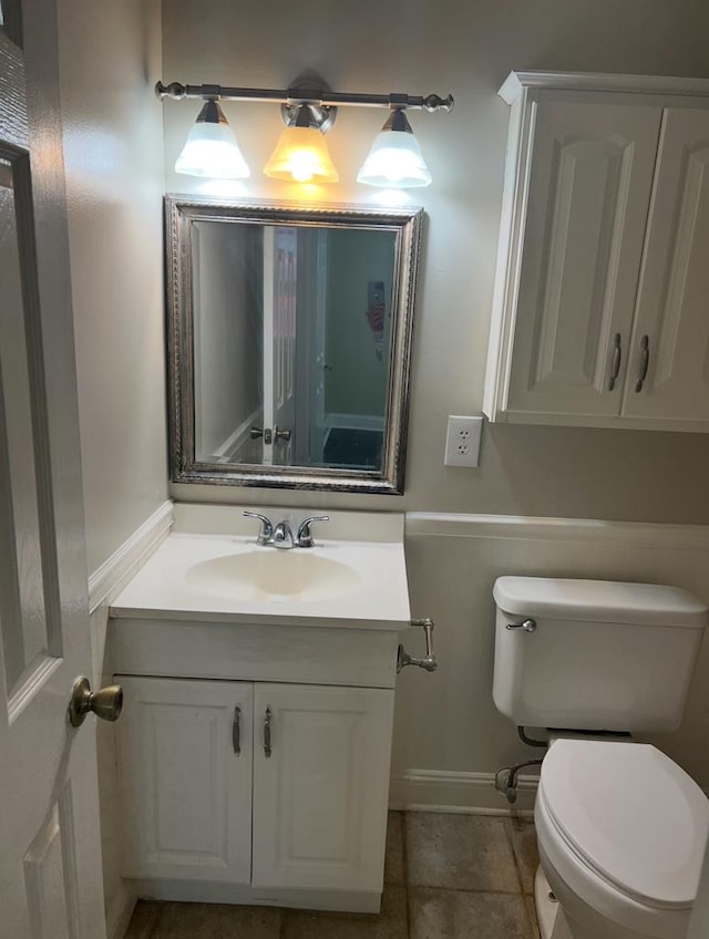 bathroom featuring toilet, tile patterned flooring, and vanity