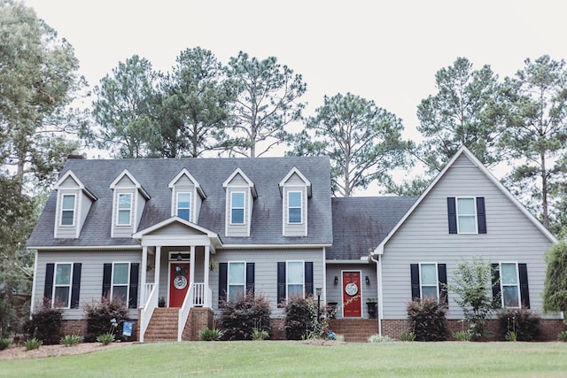 new england style home with a front lawn