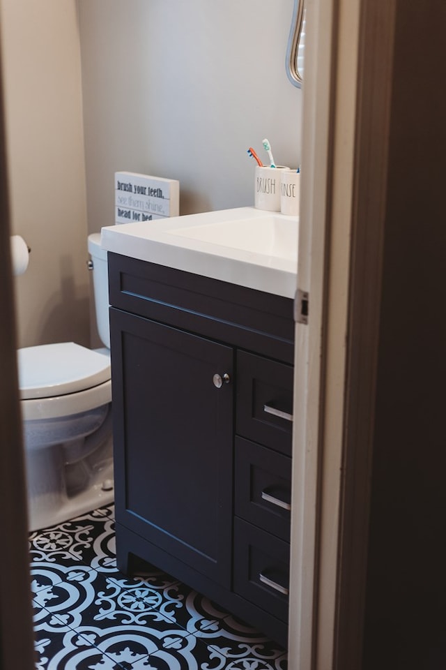 bathroom featuring vanity, toilet, and tile patterned floors