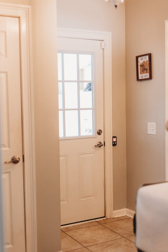 entryway with light tile patterned flooring