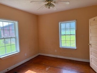 726 Oglethorpe Ave, Americus, GA 31709 - spare room with healthy amount of natural light, ceiling fan, wood finished floors, and a textured ceiling