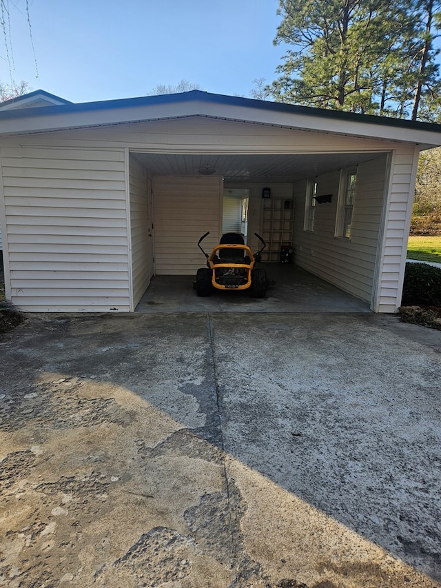 exterior space with a carport and concrete driveway