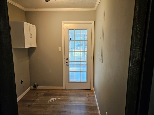 doorway to outside with baseboards, ornamental molding, and wood finished floors