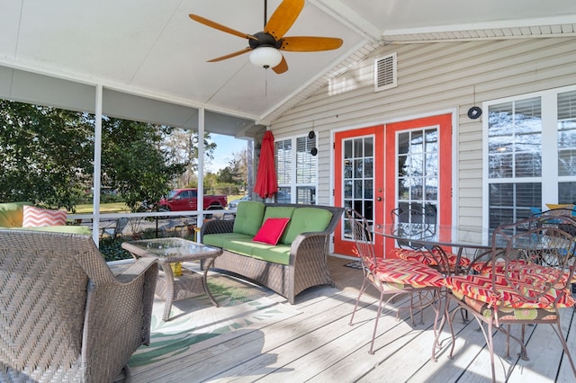 deck featuring french doors, a ceiling fan, and outdoor dining space