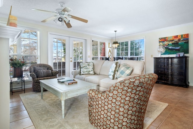 tiled living area with french doors, a healthy amount of sunlight, crown molding, and a textured ceiling