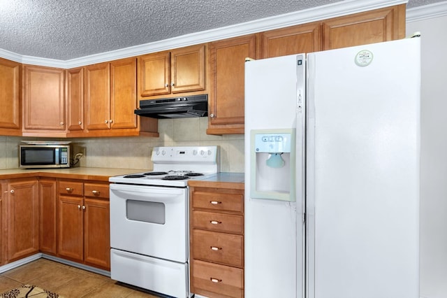 kitchen featuring light countertops, white appliances, brown cabinetry, and under cabinet range hood