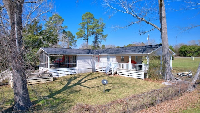 view of front of property with covered porch, a front lawn, crawl space, and a sunroom