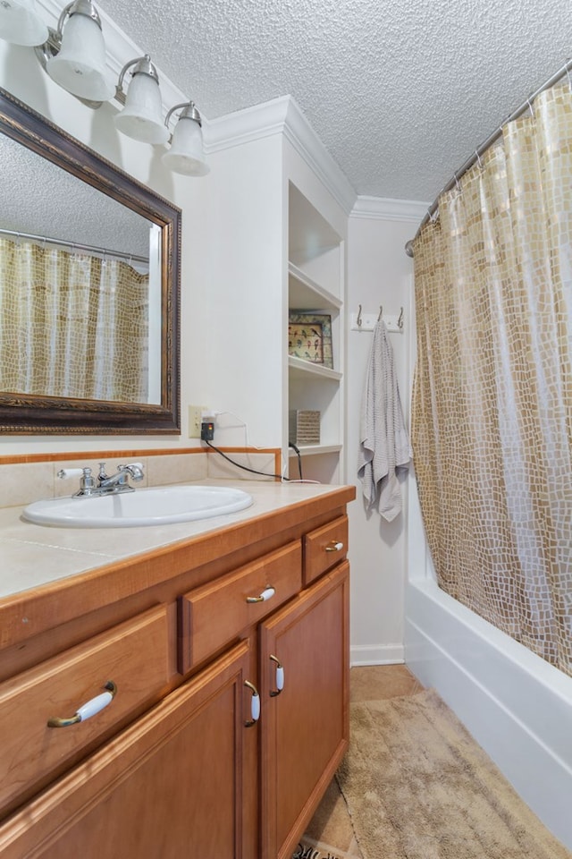 bathroom with a textured ceiling, ornamental molding, shower / bath combo, and vanity