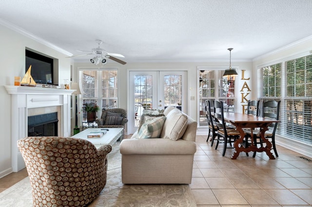 living room featuring light tile patterned floors, a fireplace, ornamental molding, and a textured ceiling