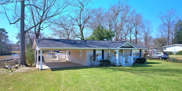 view of outdoor structure featuring a porch, an attached carport, and driveway