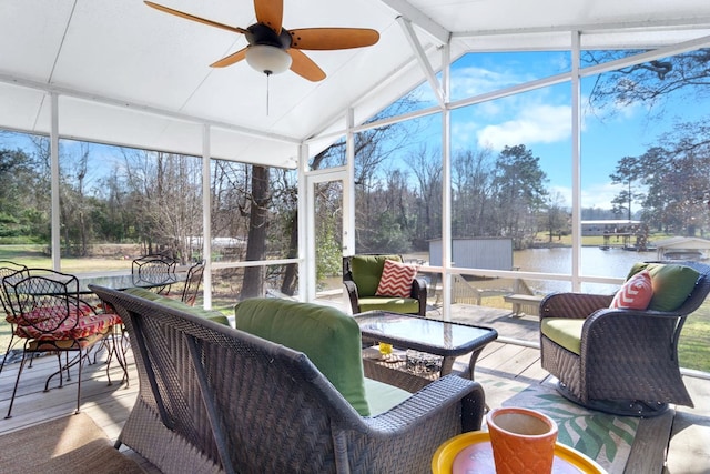 sunroom / solarium with a water view, ceiling fan, and lofted ceiling with beams