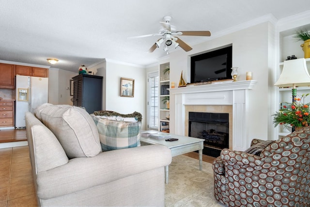 living area featuring ornamental molding, a fireplace, a textured ceiling, and light tile patterned floors