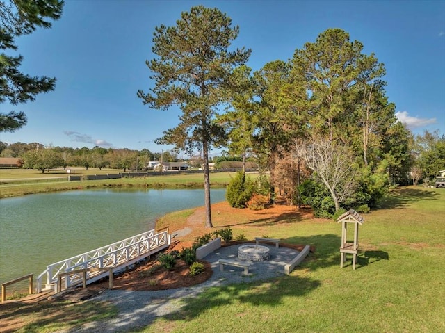 exterior space featuring a lawn and a water view