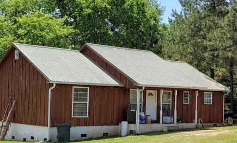 exterior space featuring a porch and a lawn