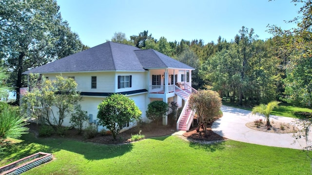 view of front of home featuring covered porch and a front lawn