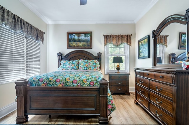 bedroom with light wood-type flooring, ceiling fan, and ornamental molding