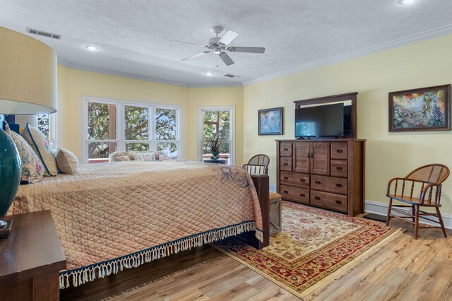 bedroom featuring a textured ceiling, ceiling fan, and ornamental molding