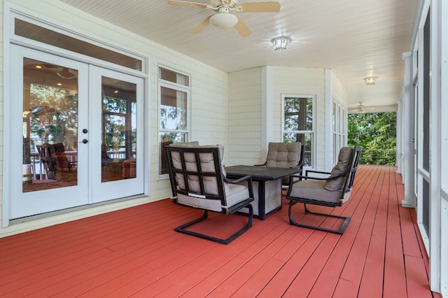 sunroom / solarium featuring ceiling fan and french doors