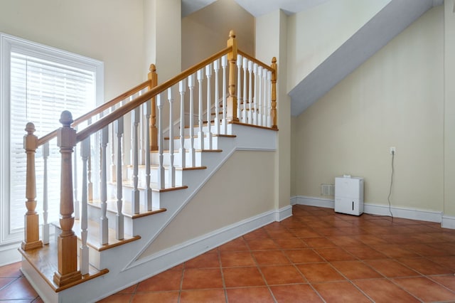 staircase with tile patterned floors