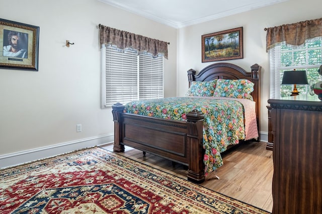 bedroom featuring hardwood / wood-style flooring and ornamental molding