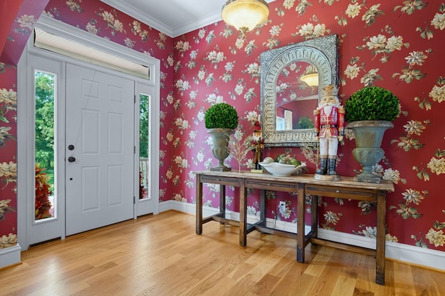 entrance foyer with crown molding and hardwood / wood-style flooring