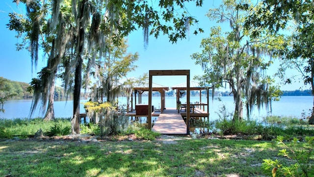 view of dock featuring a water view and a yard