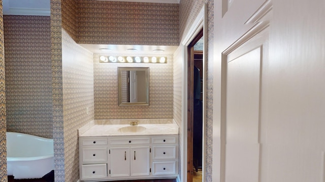 815 E 19th Ave, Cordele, GA 31015 - full bathroom featuring wallpapered walls, a freestanding tub, vanity, and crown molding