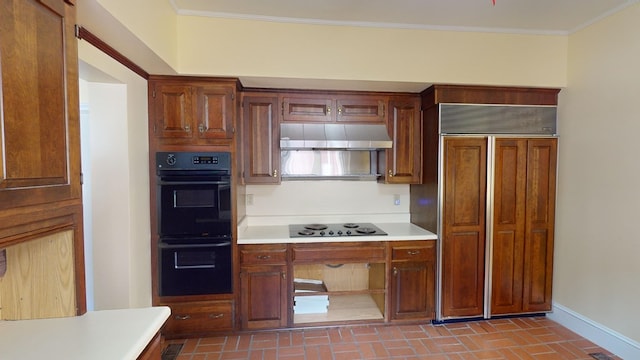 815 E 19th Ave, Cordele, GA 31015 - kitchen featuring black appliances, light countertops, brick patterned flooring, baseboards, and under cabinet range hood