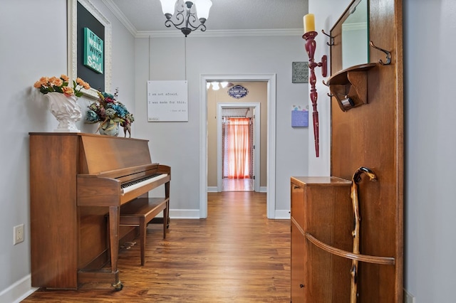 corridor with baseboards, wood finished floors, and crown molding