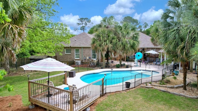 view of pool featuring a lawn, fence, and a fenced in pool