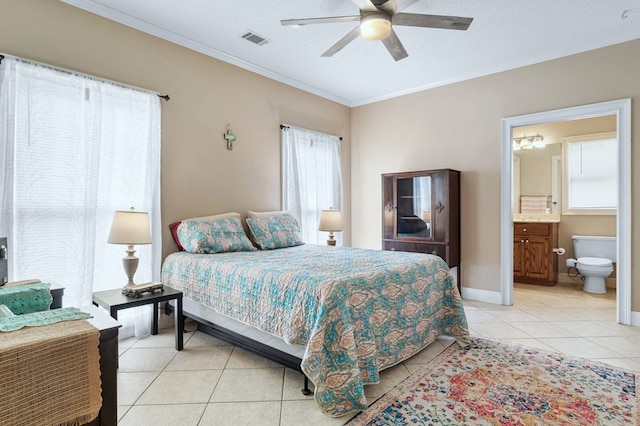 bedroom with a ceiling fan, crown molding, ensuite bathroom, light tile patterned floors, and visible vents