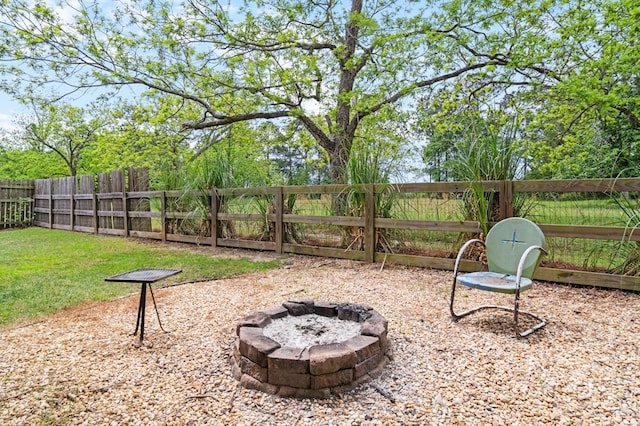 view of yard with a fenced backyard and an outdoor fire pit