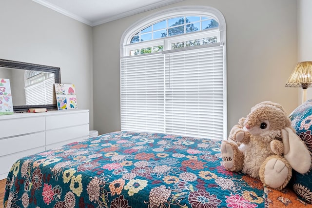 bedroom featuring wood finished floors and crown molding
