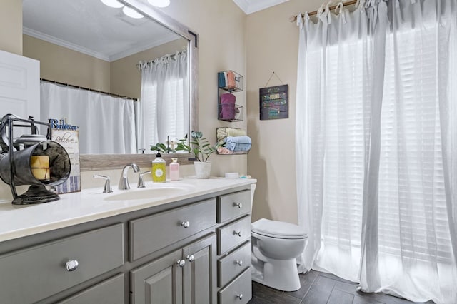 full bathroom featuring wood finished floors, crown molding, vanity, and toilet