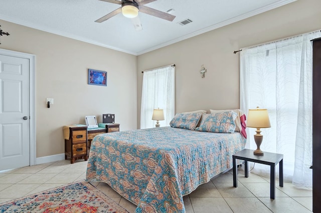 bedroom with light tile patterned floors, visible vents, baseboards, ceiling fan, and ornamental molding