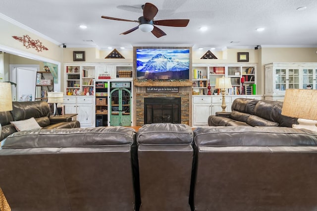 living room featuring ceiling fan, crown molding, built in features, and a fireplace