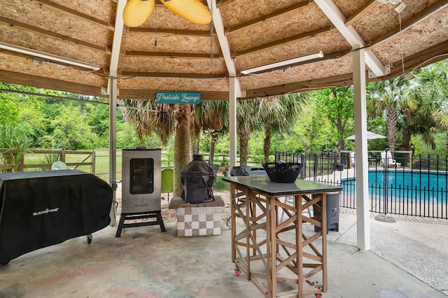 view of patio / terrace featuring fence, a fenced in pool, a gazebo, and area for grilling