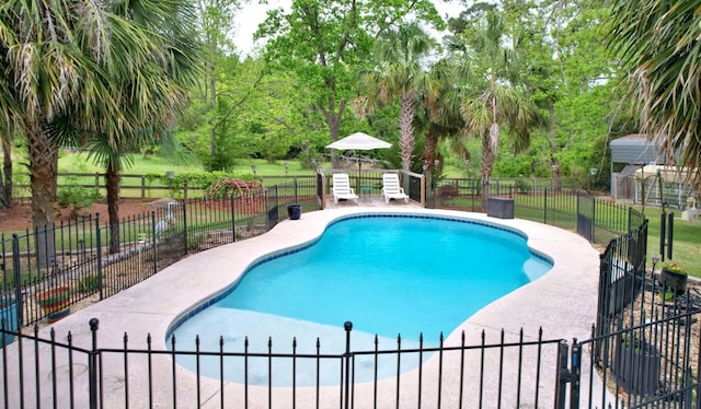 view of pool with a fenced in pool and fence