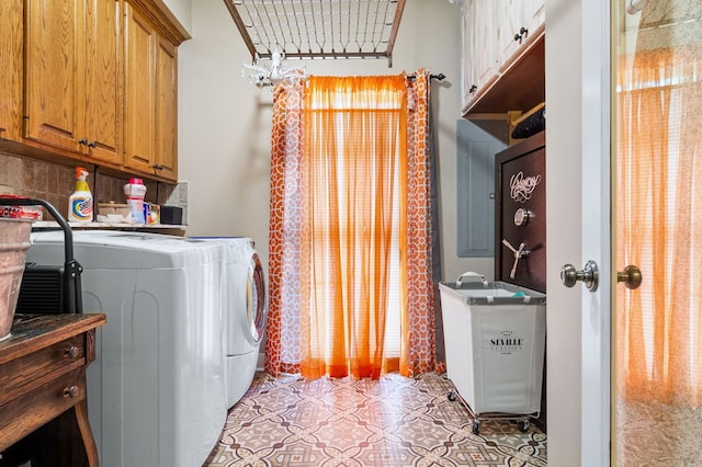 washroom with cabinet space, light tile patterned floors, a sink, and separate washer and dryer
