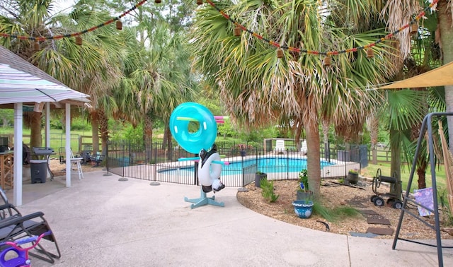 view of swimming pool featuring a water slide, fence, and a fenced in pool