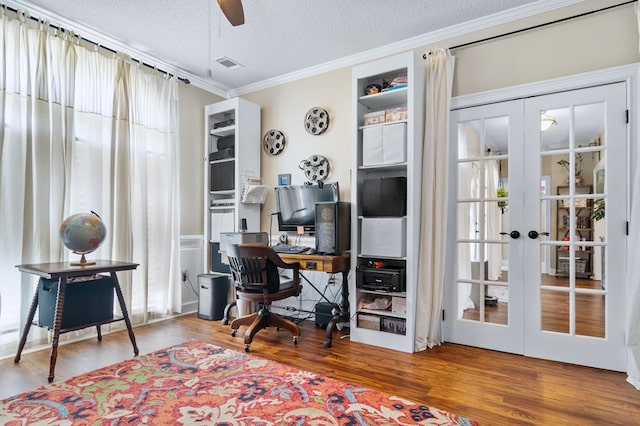 office space with french doors, visible vents, wood finished floors, ceiling fan, and ornamental molding